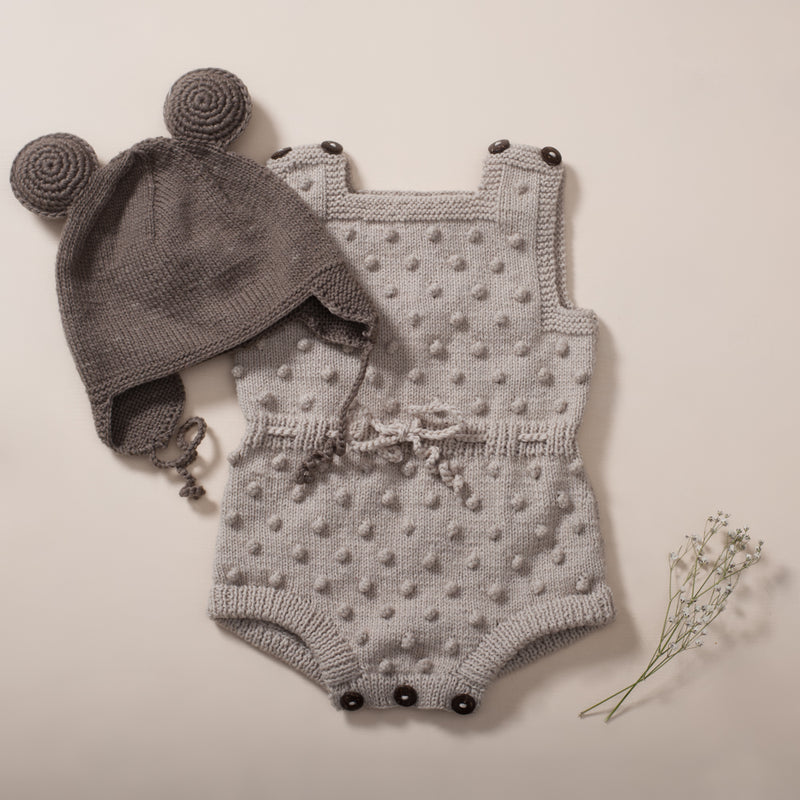 flatlay picture of bubble romper oats and remy mouse hat in nutty brown