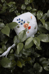 Midsummer Bonnet displayed in a nature setting