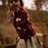 little girl wearing hellebores cardigan in grape