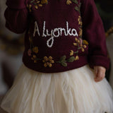 girl wearing personalized blackberries sweater with embroidered details