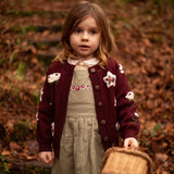 little girl wearing hellebores cardigan in grape