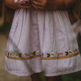 Detail of the Birdie Bliss Dress - Lilac, showcasing the embroidered decorations.