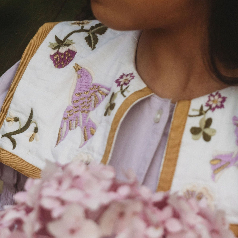 Close-up of the Birdie Bliss Dress - Lilac, focusing on the collar, worn by someone.