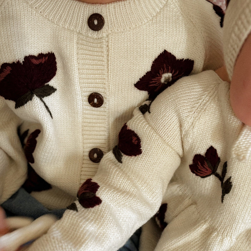 girls wearing knitted and embroidered hellebores knitwear