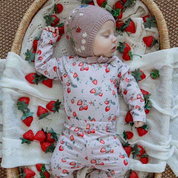 baby in a strawberry outfit