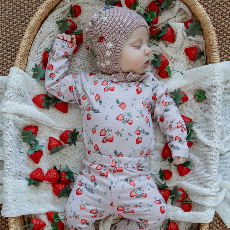 baby in a strawberry outfit