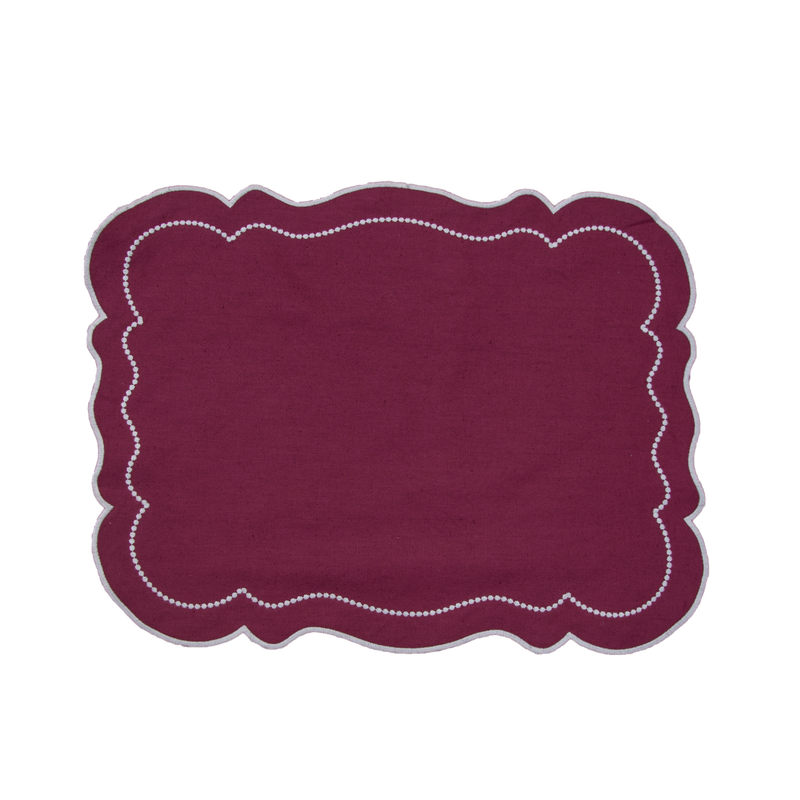 Embroidered Dot placemat in grape color featuring delicate embroidered dots, a flowing wave pattern, and elegantly scalloped edges, adding sophistication and festive charm to your table setting.