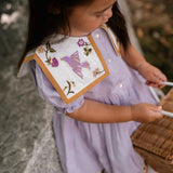 Birdie Bliss Dress - Lilac worn by a child.