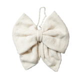 Hand-knitted cream Christmas bow made from 100% sheep wool, showcasing its large size and intricate craftsmanship.