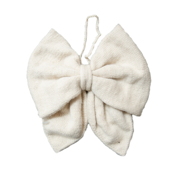 Hand-knitted cream Christmas bow made from 100% sheep wool, showcasing its large size and intricate craftsmanship.