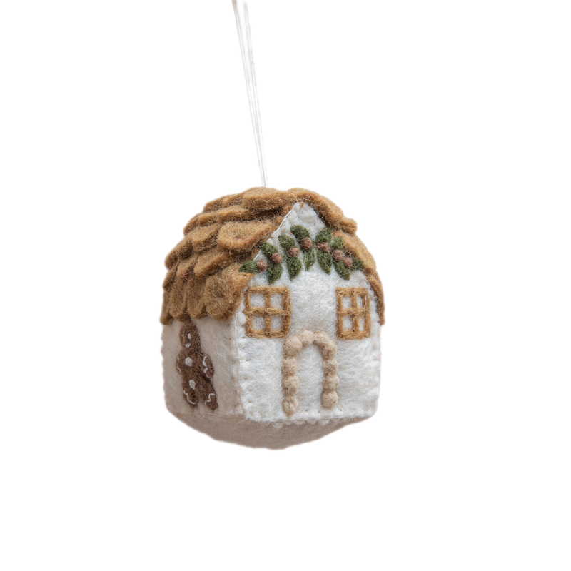 Handcrafted gingerbread house ornament in white, featuring intricate details and festive charm, made from 100% wool. A whimsical addition to holiday decor, showcasing meticulous craftsmanship and traditional warmth.