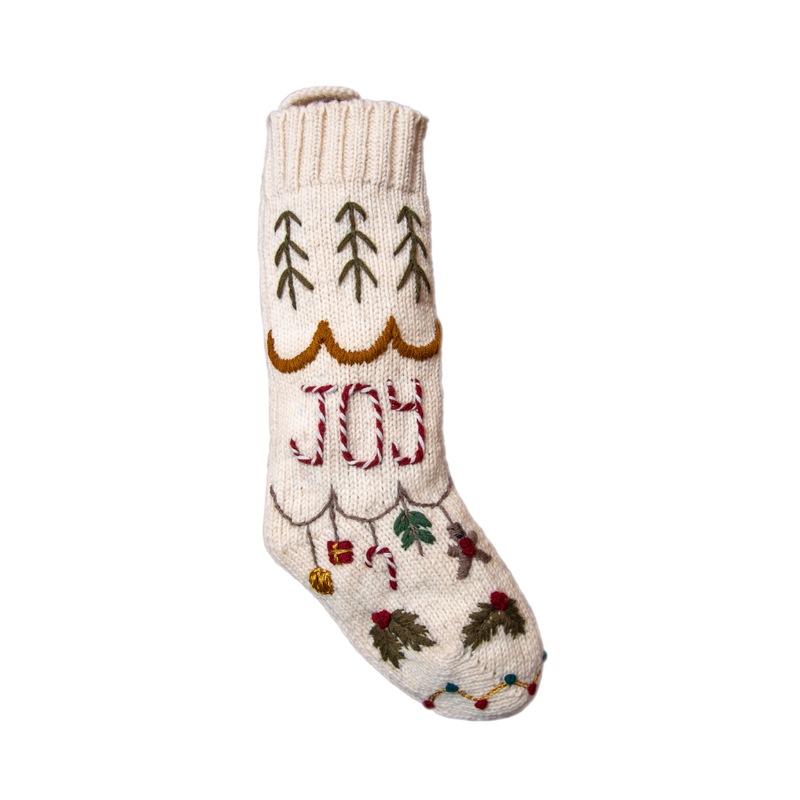 Christmas stocking with 'Joy' embroidery, showcasing hand-embroidered details and festive design, perfect for holiday decor.