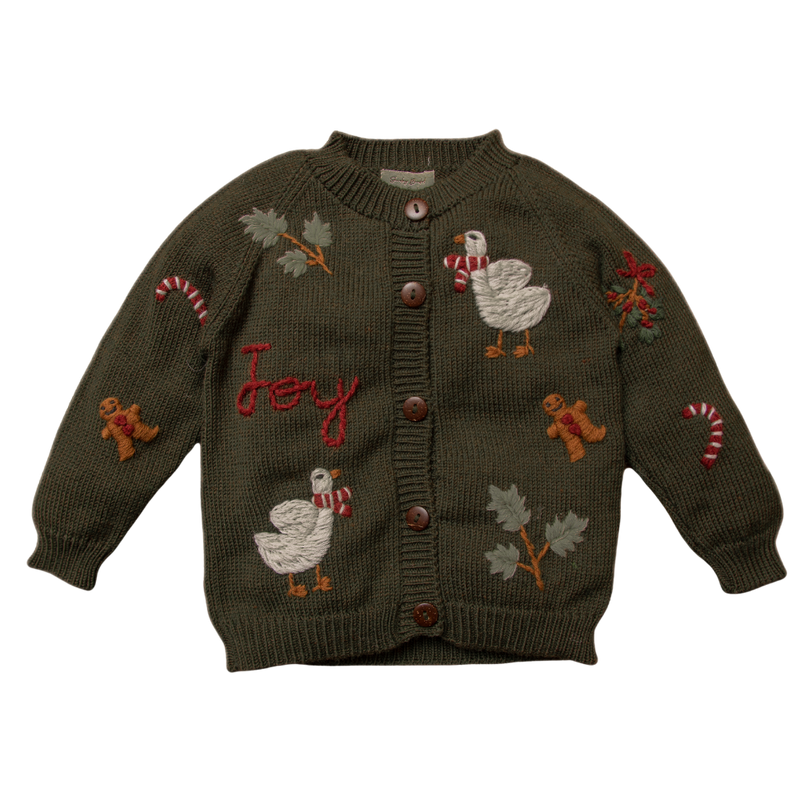 Christmas Joy Cardigan in pine green, featuring hand-embroidered holiday motifs like candy canes, gingerbread men, and festive geese, crafted from super-soft 100% merino wool for a cozy embrace.
