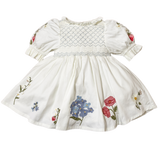 White dress with floral embroidery on a white background