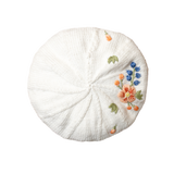 White beret with floral embroidery on a white background