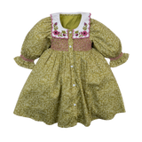 Green floral dress with embroidered pink flowers on a white background