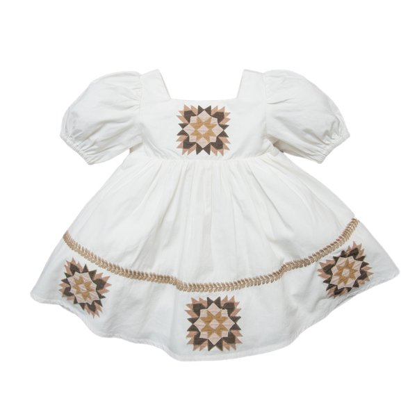 A white short-sleeved patchwork dress with geometric patterns in brown and beige accents, presented against a plain background.