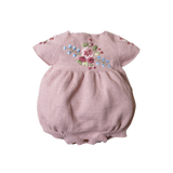 Pink baby romper with floral embroidery on a white background