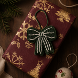 green bow napkin ring laying on a gift box