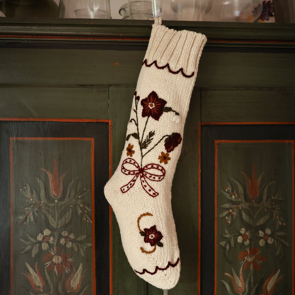 Decorative white sock with floral patterns on a wooden cabinet with floral carvings