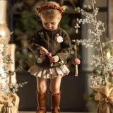 little girl in a christmas outfit featuring our knitted and embroidered holiday goose cardigan in pine color