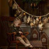 little girl in a christmas mood with a knitted advent calendar