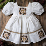 white patchwork dress on a wooden background