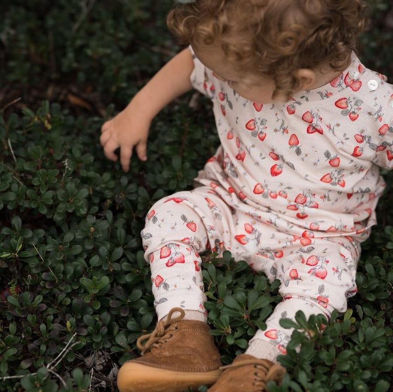 girl in the garden wearing strawberry jersey printed t shirt and leggings