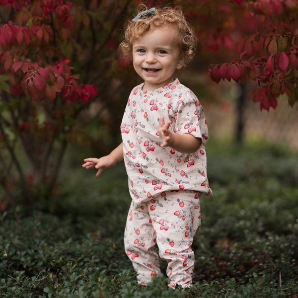 girl in the garden wearing strawberry jersey printed t shirt and leggings