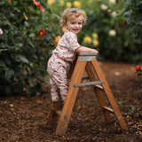 girl in the garden wearing strawberry jersey printed t shirt and leggings