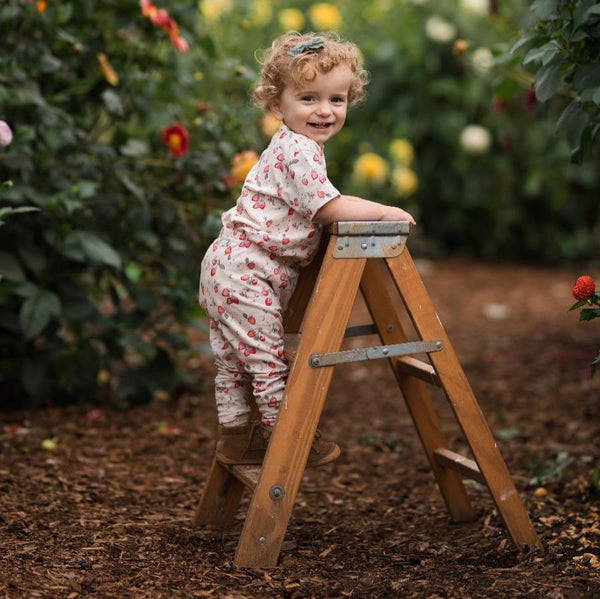 girl in the garden wearing strawberry jersey printed t shirt and leggings