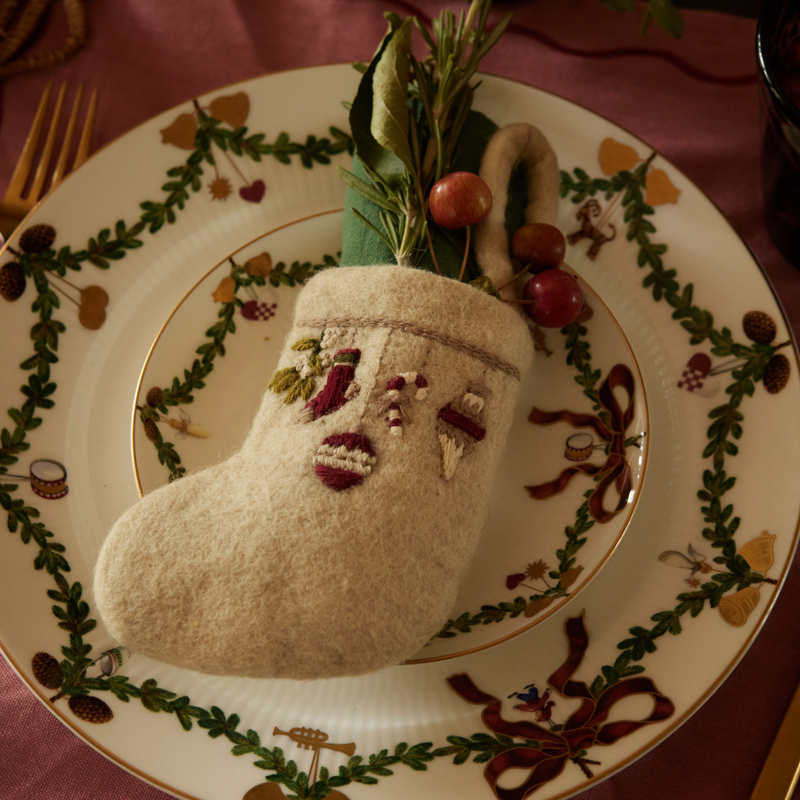 Mini Stocking Garland with intricate embroidery, displayed on a decorative plate