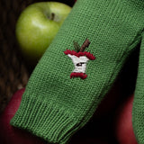 close up of the sleeve with embroidered apple
