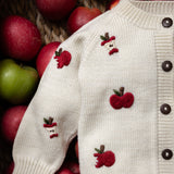close up of the cream white apple cardigan for children