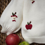 close up of the white apple sweater