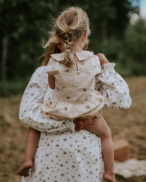 Mother with her daughter in our embroidered romper for kids
