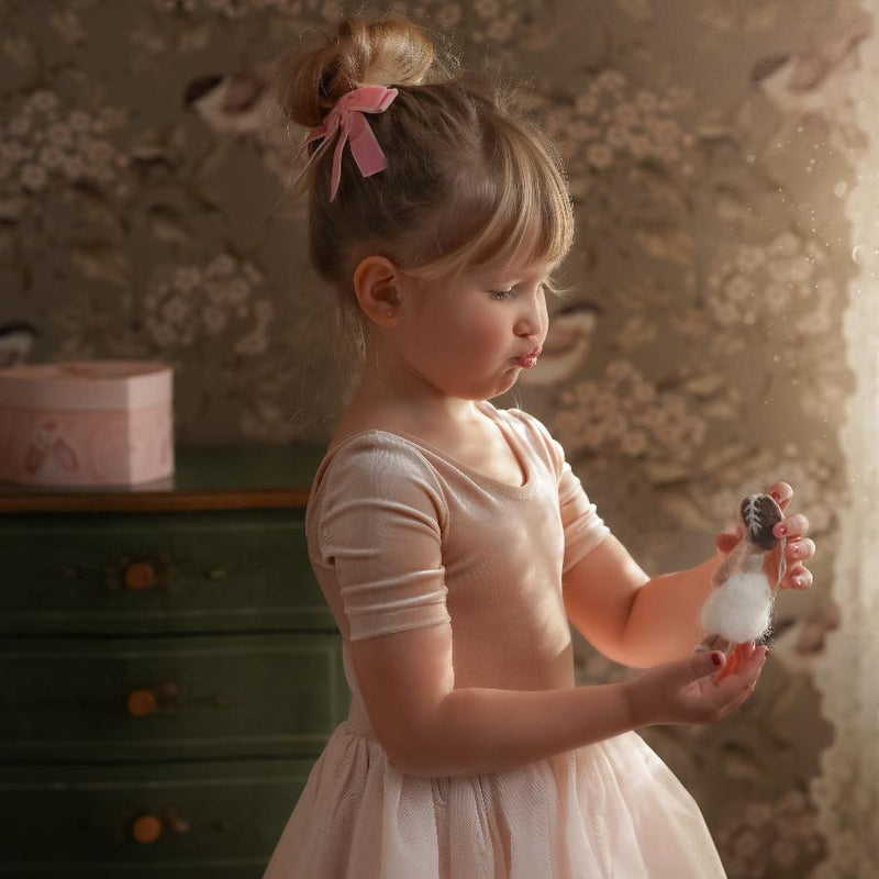 little girl holding a felted ballerina ornament