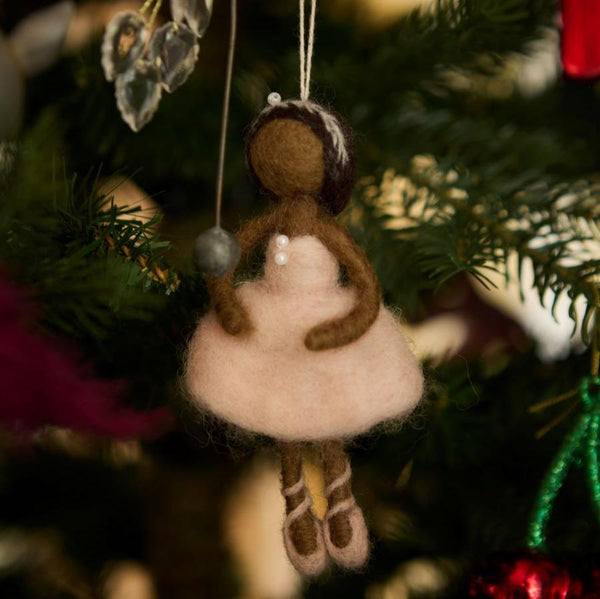 ink hand-felted ballerina ornament hanging on a Christmas tree. Crafted from soft, high-quality wool, it adds a touch of elegance and charm to holiday decorations.