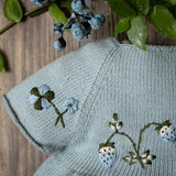 blue knitted and hand embroidered botanical romper