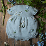 blue knitted and hand embroidered botanical romper