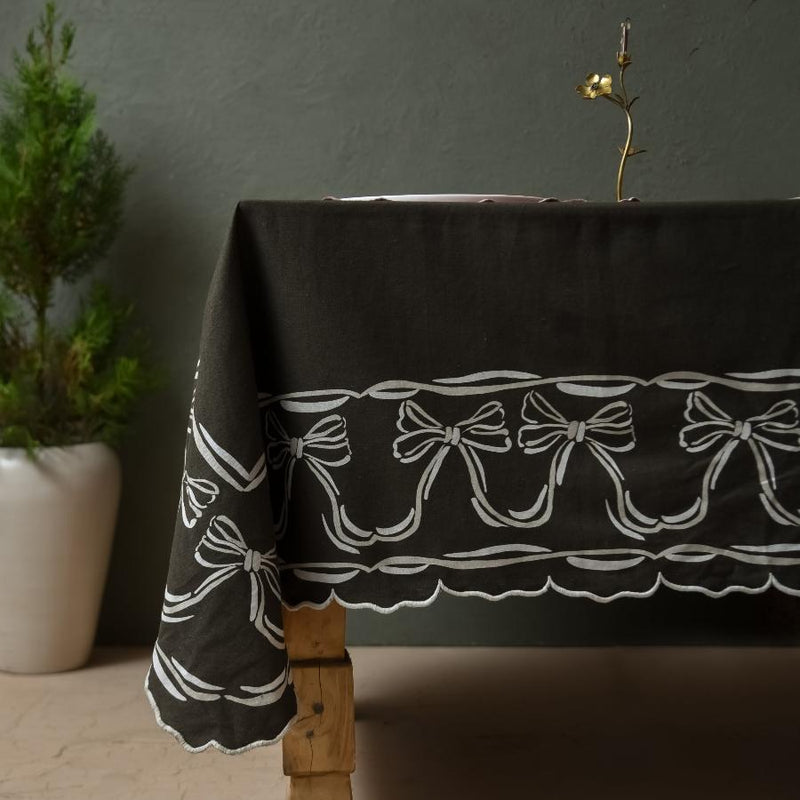 dark green tablecloth for holidays with printed white bows on edges