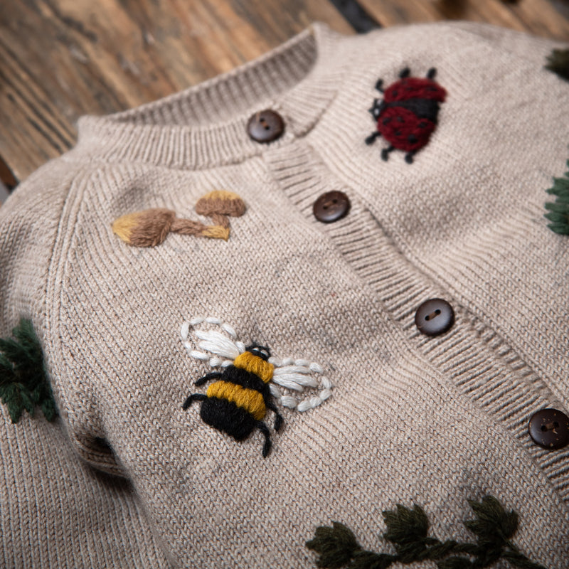 close up of knitted and embroidered bugs life cardigan for children