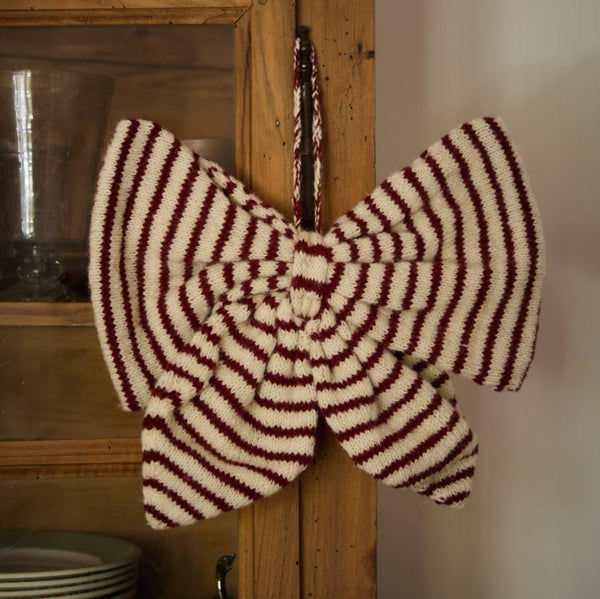 Big Christmas Bow in Stripe Red color displayed on cabinets, bringing a festive and traditional touch to holiday decorations.