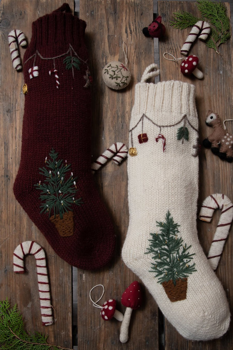 knitted stocking for christmas in white and grape color with hand embroidered christmas tree and garland