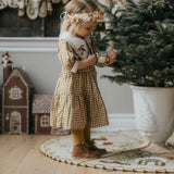 Girl standing on our gingerbread rug