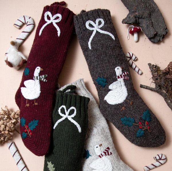 Collection of Goose Stockings in various colors, including Dark Grape, featuring hand-embroidered Christmas goose designs.