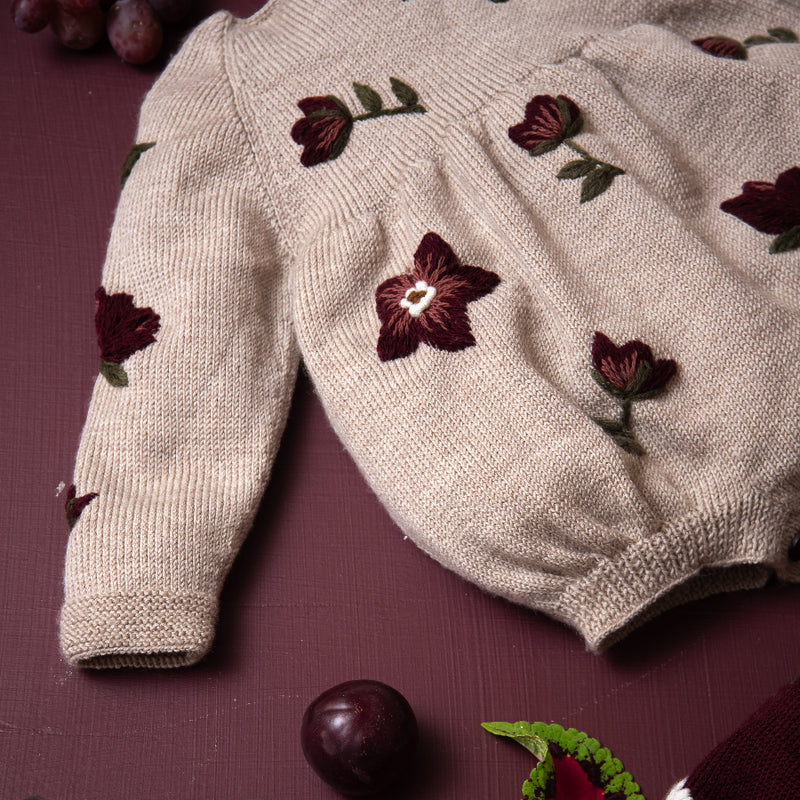 knitted and embroidered hellebores romper for babies