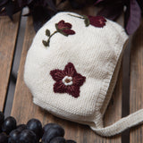 knitted and embroidered hellebores bonnet