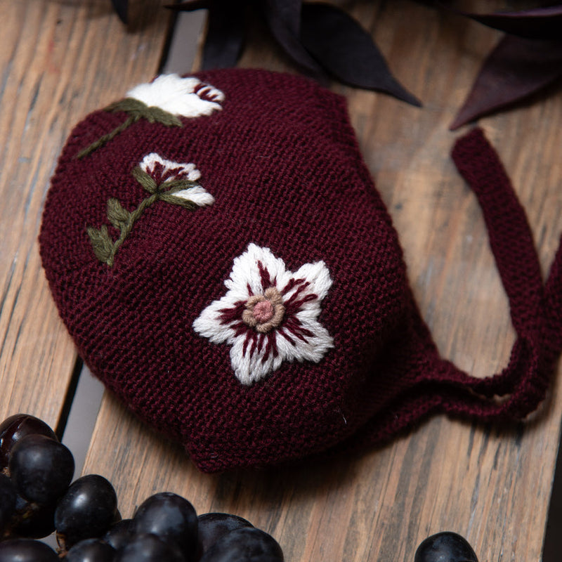 knitted and embroidered hellebores bonnet