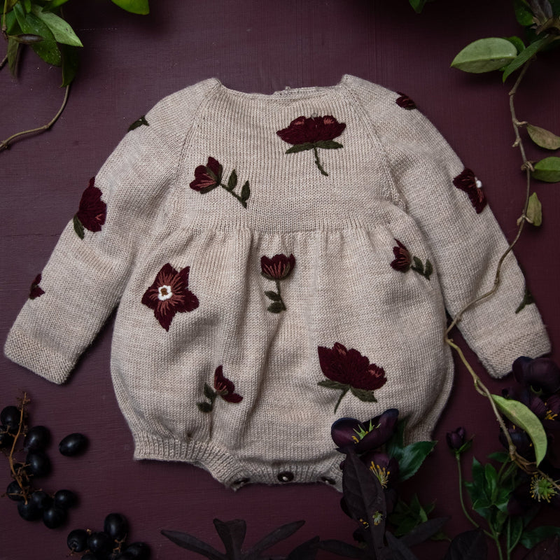 knitted and embroidered hellebores romper for children